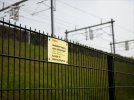 Example from the Netherlands(Prohibitive sign on the fence along the tracks