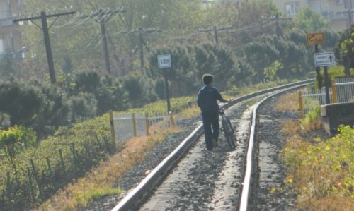 Child walking along the tracks
